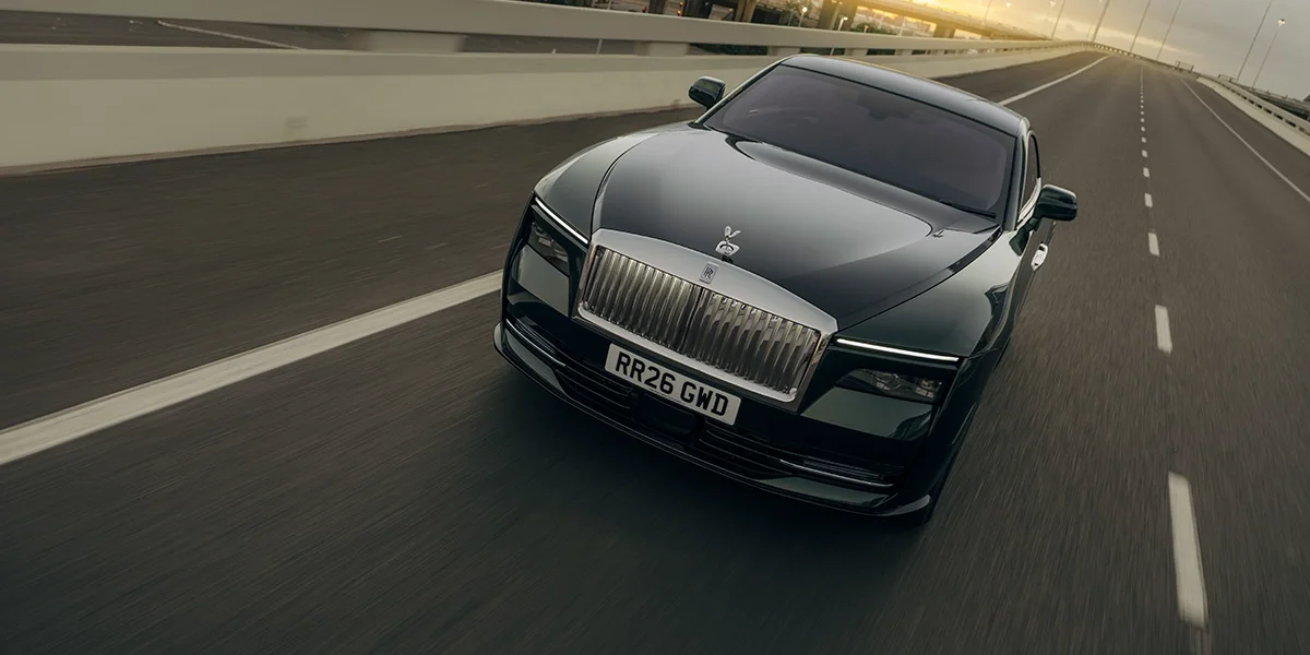 2027 Rolls-Royce Spectre Series II exterior with Dark Emerald paint, Coachline, and illuminated grille options
